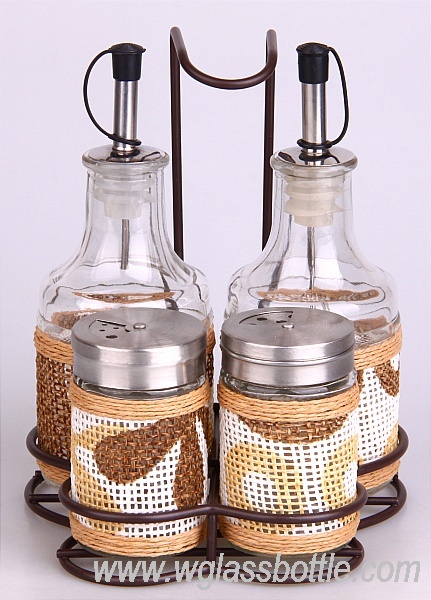 Set of glass oil bottles and spice jars in an iron shelf